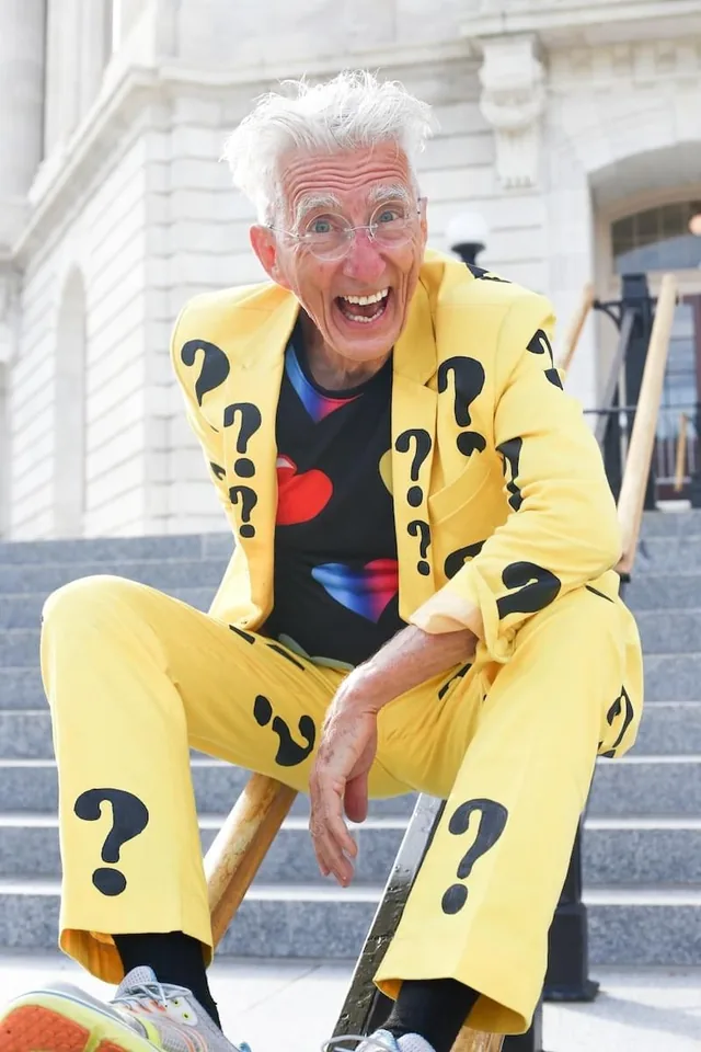 Matthew Lesko in his famous yellow question mark suit on the steps of a government building